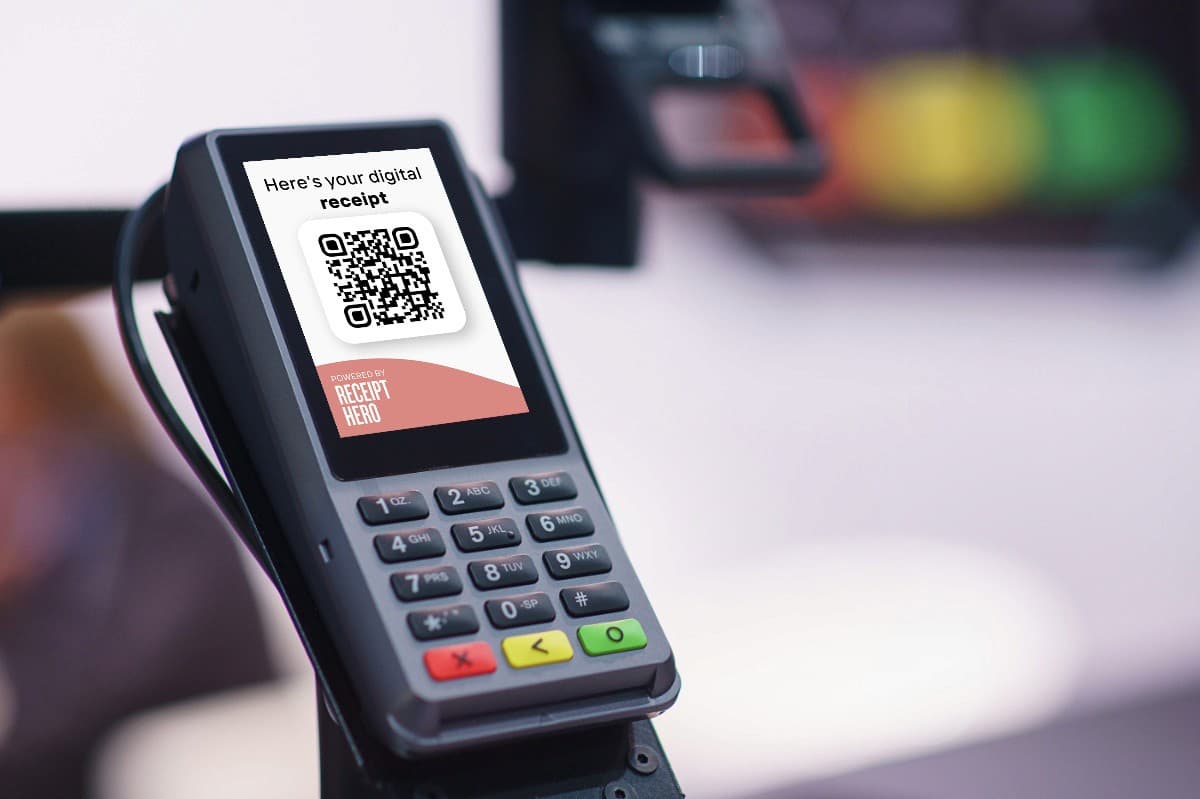 A card terminal screen showing Here is your digital receipt above a QR code, badged Powered by ReceiptHero