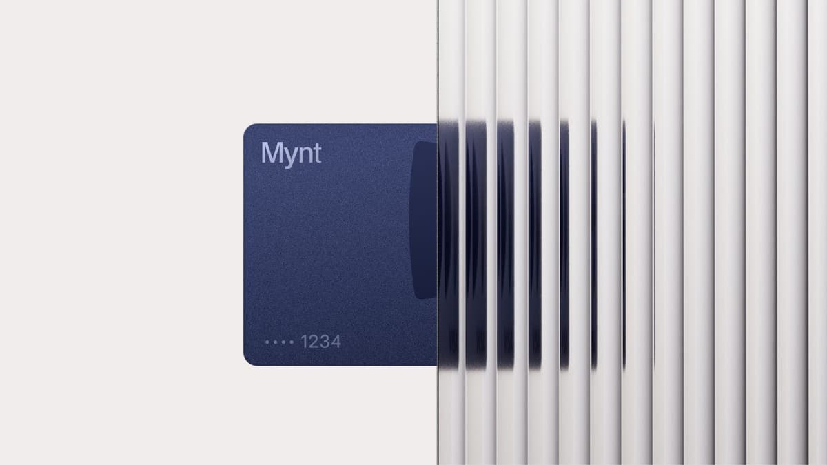 A dark blue Mynt payment card ending 1234, half in front of a fluted white panel