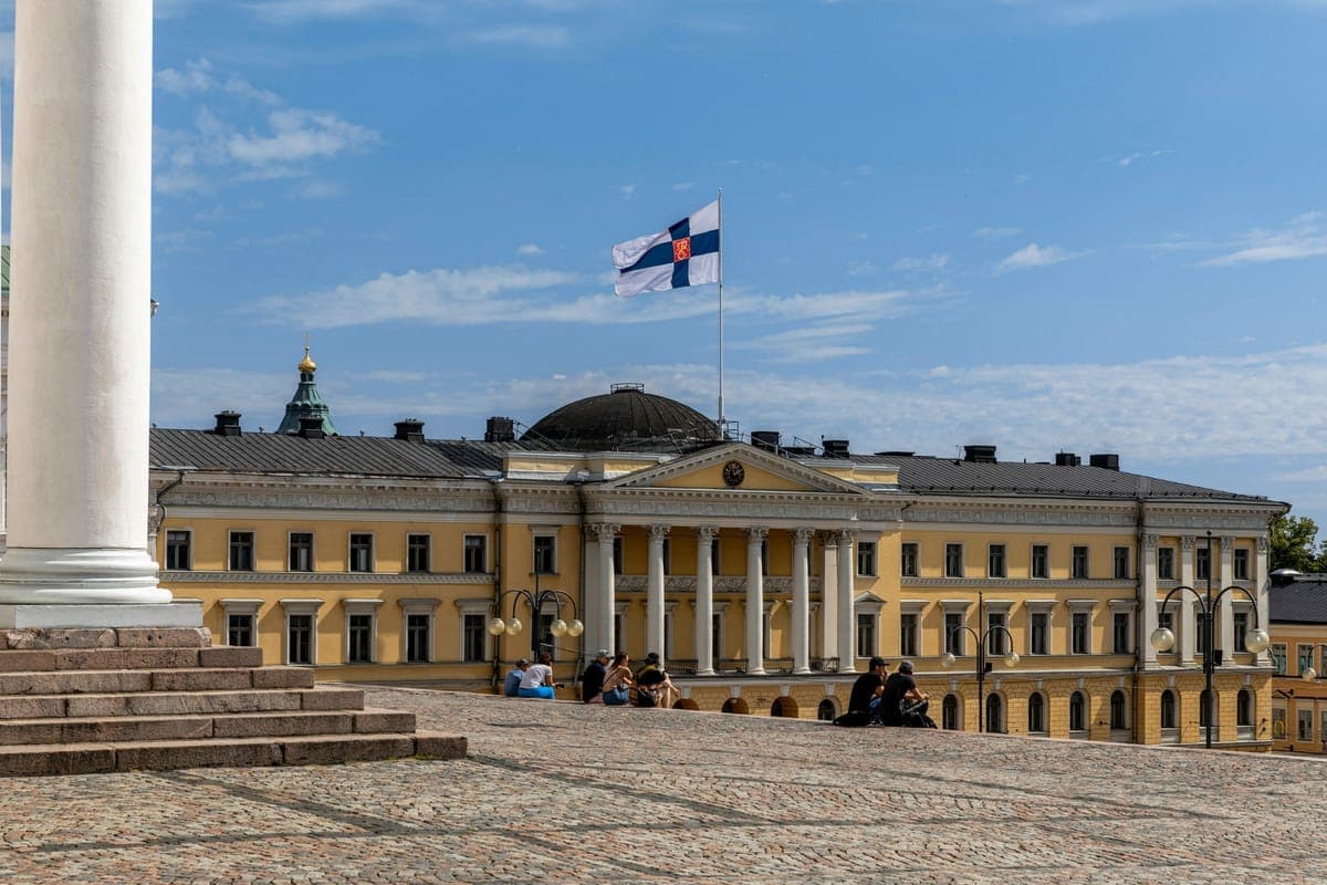 The Finnish flag flying above the Government Palace on Senate Square in Helsinki