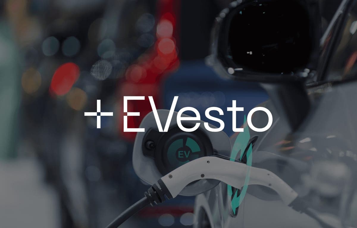 The EVesto logo over a close-up of a charging cable plugged into an electric car