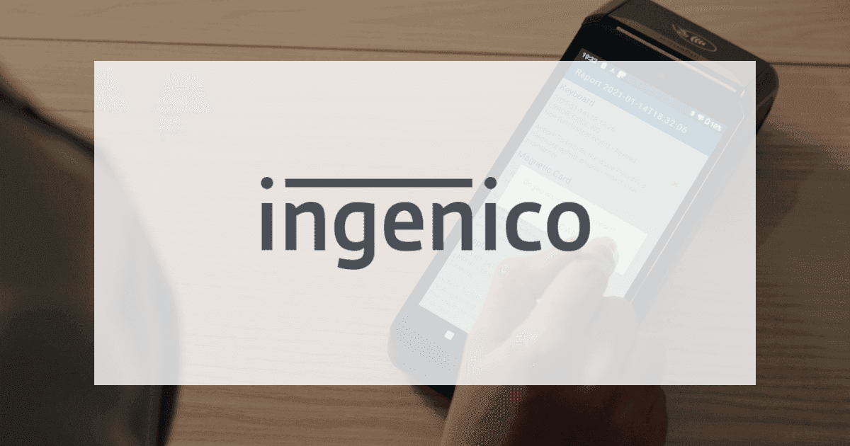 The Ingenico logo over a photo of a hand using a card terminal on a wooden counter