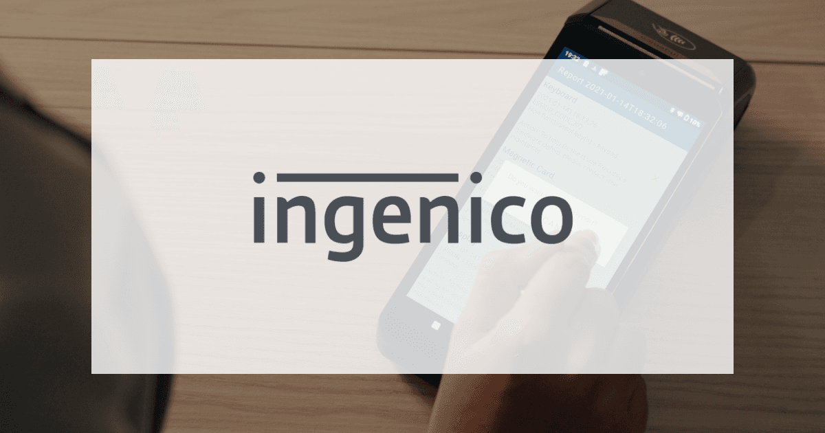 The Ingenico logo over a photo of a hand using a card terminal on a wooden counter
