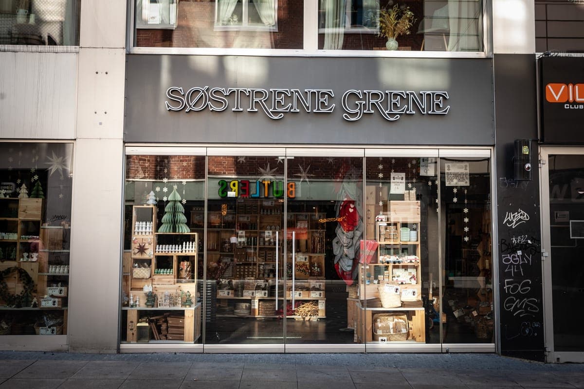 The shopfront of a Sostrene Grene store, its window dressed with wooden crates and Christmas decorations