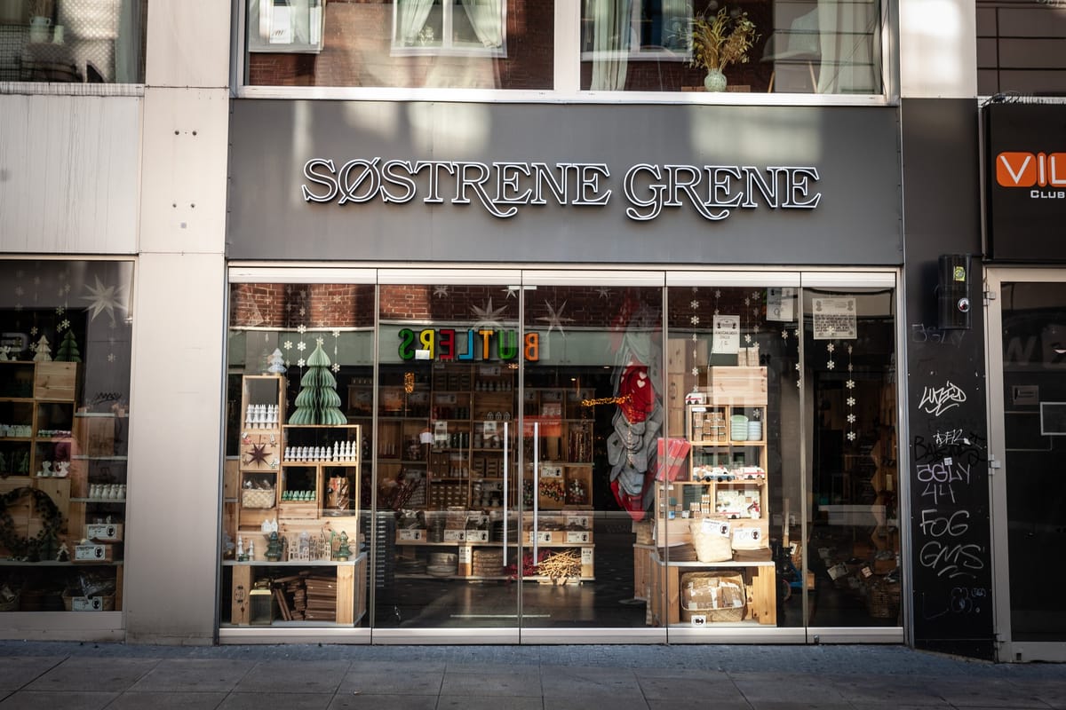 The shopfront of a Sostrene Grene store, its window dressed with wooden crates and Christmas decorations