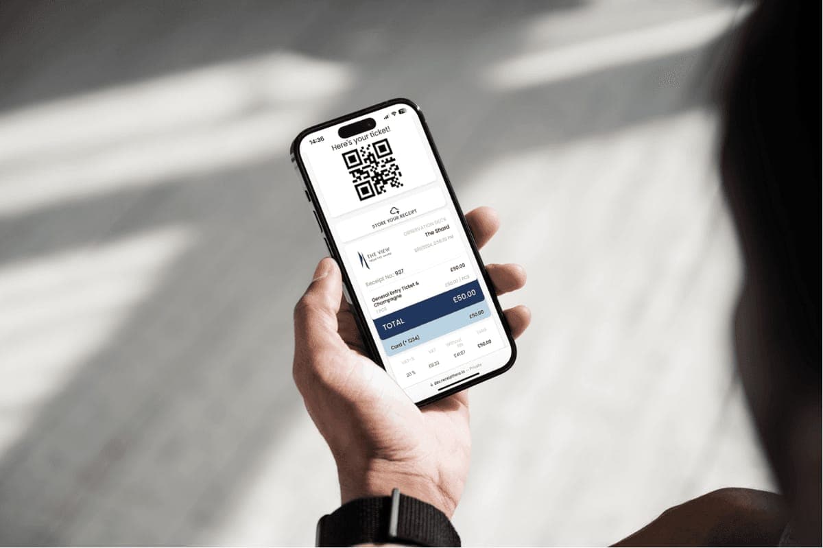 A hand holding a phone showing a digital ticket and receipt for The View from The Shard, with a QR code and a 50 pound total