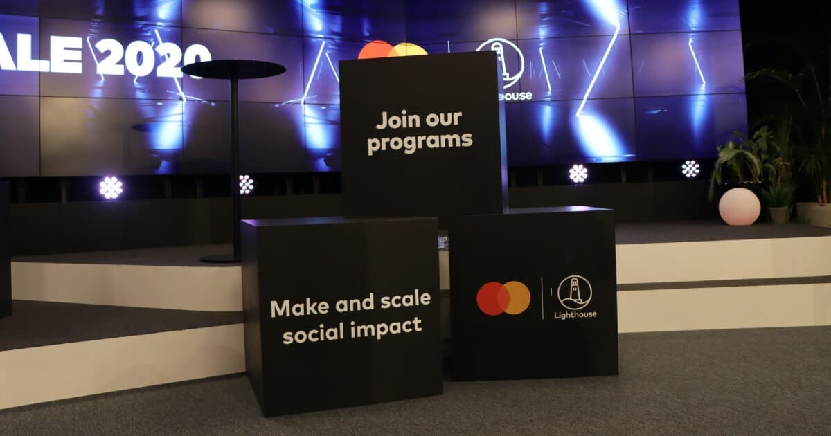 Branded plinths at a Mastercard Lighthouse event reading Join our programs and Make and scale social impact