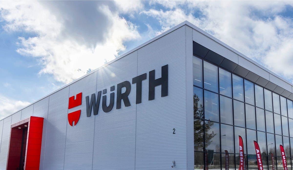 The corner of a Wurth store building in winter sunlight, the brand name mounted on its metal facade